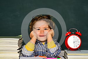 September 1. Blackboard copy space. Back to school. Funny little boy pointing up on blackboard. Great study achievement.