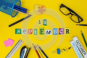 September 13th. Day 13 of month, Back to school concept. Calendar on teacher or student workplace background with school