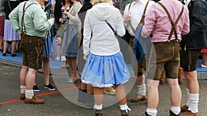 September 17, 2017 - Munich, Germany:Crowd of people in national Bavarian suits Dirdl and Lederhose are walking along