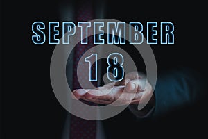 september 18th. Day 18 of month, announcement of date of business meeting or event. businessman holds the name of the month and