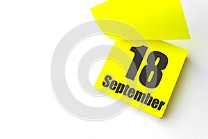 September 18th. Day 18 of month, Calendar date. Close-Up Blank Yellow paper reminder sticky note on White Background. Autumn month