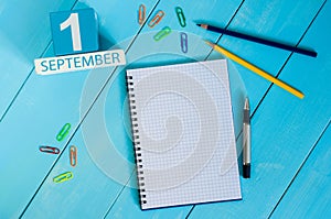 September 1st. Image of september 1 wooden color calendar on blue background. Autumn day. Empty space for text. Back to