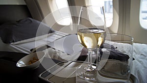 SEPTEMBER 2014: First Class Dining onboard an Boeing 747, white wine, water and nuts
