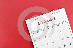 September 2024 desk calendar on red background