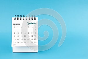 September 2024 mini desk calendar on blue color background