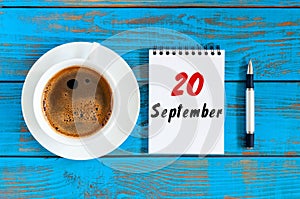 September 20th. Day 20 of month, loose-leaf calendar and coffee cup at Software Engineer workplace background. Autumn