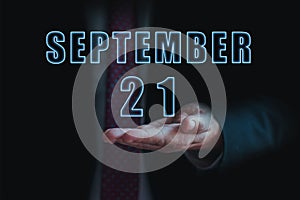 september 21st. Day 20 of month, announcement of date of business meeting or event. businessman holds the name of the month and
