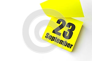 September 23rd. Day 23 of month, Calendar date. Close-Up Blank Yellow paper reminder sticky note on White Background. Autumn month