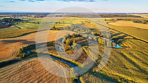 September agriculture fields aerial panorama. Sunny autumn landscape. Meadows, river, village