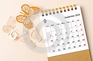 A September 2023 desk calendar for the organizer to plan and reminder and butterfly paer on yellow background