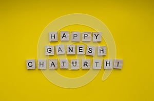 happy Ganesh Chaturthi, a minimalistic banner with an inscription in wooden letters