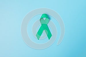 September Ovarian cancer Awareness month, teal Ribbon color on blue background for supporting people living, and illness.