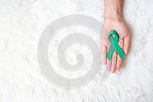 September Ovarian cancer Awareness month, Woman holding teal Ribbon color for supporting people living, and illness. Healthcare