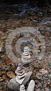 September in the Sudetes, stone piles in the current of a river