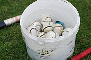 Bucket full of camogie or hurling balls, also known as sliothars