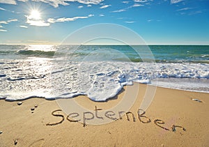 September word on sea sand