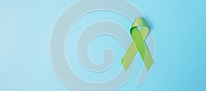 September World lymphoma and October Mental health day Awareness month, lime green Ribbon color on blue background for supporting