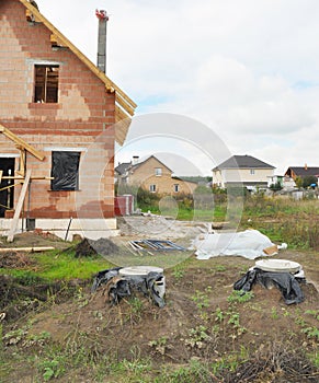 Septic manhole cover and concrete tanks installing in the house construction site