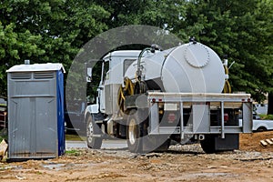 A septic truck is being used to clean portable restrooms