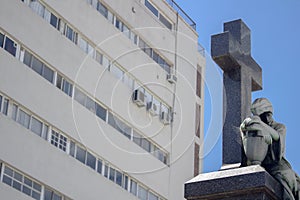 Sepulchre in front of building that suggests the difficulty of paying a mortgage