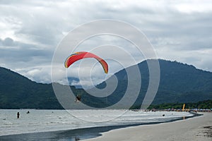 sequence of a man taking off on a paramotor on the coast on a cloudy day