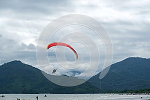 sequence of a man taking off on a paramotor on the coast on a cloudy day