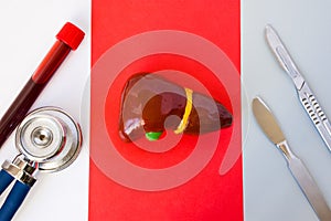 Sequence of medical items: stethoscope and laboratory test tube with blood sample, anatomical model of liver, two surgical scalpel