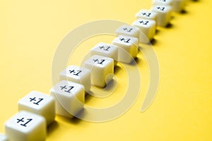 Sequential chain of blocks with plus one. Sequence. Arithmetic progression. Add one more. Increase and growth. A series concept.