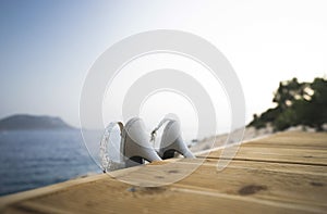 Sequin High-Heels on swimming platform.