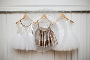 sequinned short tutus on a white hanger