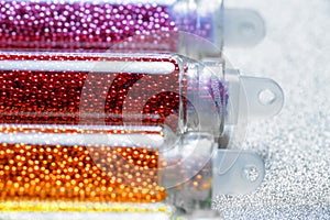 Sequins in bottles for nail design closeup