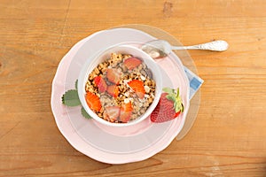 Seral with strawberries in a bowl on a pink vintage plate