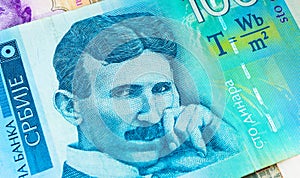 Serbian 100 dinara currency banknote, close up. Serbia money RSD dinar cash, macro view, portrait of scientist Nikola Tesla.