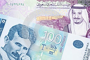 A Serbian dinar note with a Saudi Arabian riyal note