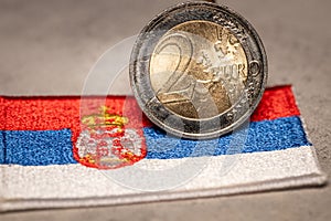 Serbian flag and 2 euro coin, Financial concept, Serbia\'s plans to join the euro zone, close up