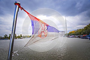 Serbian flag above river