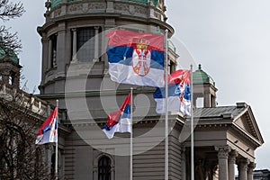 Serbian flags flutter in wind in front of National Assembly in Belgrade