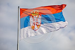 Serbian national flag on wind, outdoor