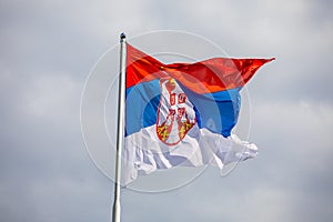 Serbian national flag on wind, outdoor