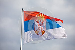 Serbian national flag on wind, outdoor