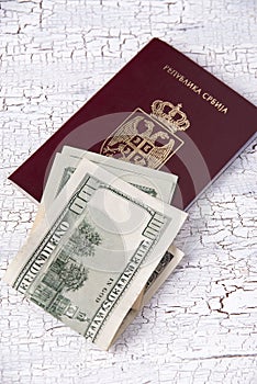 Serbian passport and money on table