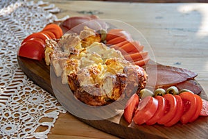 Serbian traditional food plate contain beef and pork smoked dried meet, cheese, vegetables and proja bread made of corn flour