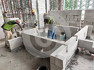 Blockwork by construction workers at the construction site.