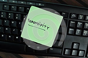 Serendipity write on sticky notes write on a sticky notes isolated on Wooden Table photo