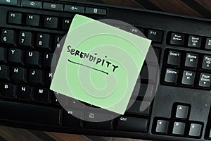 Serendipity write on sticky notes write on a sticky notes isolated on Wooden Table