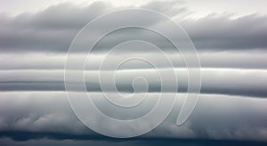 Serene cloud layers stretching across a gray sky horizon