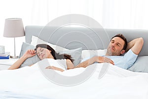 Serene couple sleeping on their bed in the morning