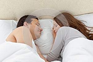 Serene couple sleeping together on their bed