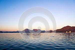 Serene dawn shot of lake with mountains in the distance