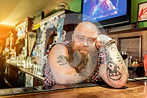 Serene fat bartender reclining on worksurface